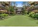 This property features a putting green, palm trees, a water feature, and lush landscaping at 7117 E Rancho Vista Dr # 3010, Scottsdale, AZ 85251