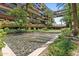 Beautiful courtyard with a water feature, lush landscaping, and a modern building backdrop at 7117 E Rancho Vista Dr # 3010, Scottsdale, AZ 85251