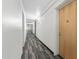 Long hallway with neutral patterned carpet leads to residences in this modern building at 7117 E Rancho Vista Dr # 3010, Scottsdale, AZ 85251