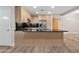 Kitchen island with granite countertops, stainless steel appliances, and natural wood cabinets at 7117 E Rancho Vista Dr # 3010, Scottsdale, AZ 85251