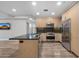 Modern kitchen featuring stainless steel appliances, wood cabinets, granite countertops, and a kitchen island at 7117 E Rancho Vista Dr # 3010, Scottsdale, AZ 85251