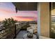 Balcony with comfortable seating and a view of the city skyline at sunset at 7180 E Kierland Blvd # 1116, Scottsdale, AZ 85254
