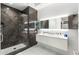 Modern bathroom features a sleek glass-enclosed shower and a double vanity with contemporary fixtures and beautiful marble details at 7180 E Kierland Blvd # 1116, Scottsdale, AZ 85254