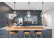Contemporary kitchen featuring a breakfast bar with stools, pendant lighting, and modern appliances at 7180 E Kierland Blvd # 1116, Scottsdale, AZ 85254