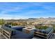 Rooftop deck with comfortable seating and a fire pit, offering panoramic city and mountain views at 7180 E Kierland Blvd # 1116, Scottsdale, AZ 85254