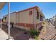 Manufactured home exterior featuring tan siding, windows, and an air conditioning unit at 8700 E University Dr # 1205, Mesa, AZ 85207