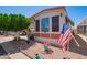 Cozy home featuring charming landscaping and a convenient golf cart parked nearby at 8700 E University Dr # 1205, Mesa, AZ 85207