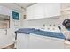 Functional laundry room featuring a side-by-side washer and dryer with overhead cabinets at 8700 E University Dr # 1205, Mesa, AZ 85207
