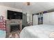 Cozy bedroom featuring an electric fireplace, large television, closet space and a comfortable bed at 8700 E University Dr # 1205, Mesa, AZ 85207