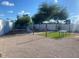 Well-maintained backyard with a grassy area, gravel, a fire pit, and a table to maximize your outdoor experience at 903 W Jacinto Cir, Mesa, AZ 85210