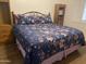 Bright bedroom featuring a bed with floral comforter and wood look flooring at 903 W Jacinto Cir, Mesa, AZ 85210