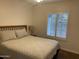 Comfortable bedroom featuring a queen-size bed and window with plantation shutters at 903 W Jacinto Cir, Mesa, AZ 85210