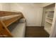 Cozy bedroom with a wooden bunk bed and adjacent closet with storage shelves at 903 W Jacinto Cir, Mesa, AZ 85210