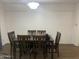 Classic dining room with a wooden table and chairs, illuminated by a central light fixture at 903 W Jacinto Cir, Mesa, AZ 85210