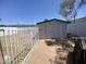 A detached garage with a brick-paved driveway next to a backyard surrounded by a white metal fence at 903 W Jacinto Cir, Mesa, AZ 85210