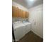 Functional laundry room with wooden cabinets and washer and dryer units at 903 W Jacinto Cir, Mesa, AZ 85210