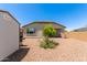 View of the gravel backyard with a desert landscaped yard with covered patio at 9325 W Montecito Ave, Phoenix, AZ 85037