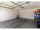 Spacious garage with white walls and concrete floor and overhead lighting at 9325 W Montecito Ave, Phoenix, AZ 85037