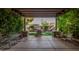 Covered patio overlooking a well-maintained backyard with a built-in grill at 10529 E Posada Ave, Mesa, AZ 85212