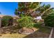 Backyard featuring mature trees, lush lawn, and a water feature at 10529 E Posada Ave, Mesa, AZ 85212
