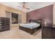 An ample main bedroom featuring a decorative ceiling fan, carpeted floors, and modern decor at 10529 E Posada Ave, Mesa, AZ 85212