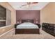 A generous main bedroom showcasing a ceiling fan, large window, and plenty of closet space at 10529 E Posada Ave, Mesa, AZ 85212