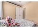 A comfortable bedroom features a floral bedspread, neutral walls, and a double door closet at 10529 E Posada Ave, Mesa, AZ 85212