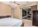 A main bedroom with sliding glass doors to the exterior, neutral paint, and carpeted floors at 10529 E Posada Ave, Mesa, AZ 85212