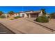 Beautiful one-story home boasting a long driveway, desert landscaping, and a two-car garage at 10529 E Posada Ave, Mesa, AZ 85212