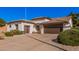 Inviting single-level home with a well-manicured yard, desert landscaping, and two-car garage at 10529 E Posada Ave, Mesa, AZ 85212