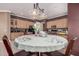 An eat-in kitchen area featuring wood cabinetry, neutral walls and lighting fixture above the round table at 10529 E Posada Ave, Mesa, AZ 85212