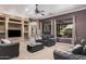 Open living room with lots of natural light, comfortable sofas, carpet floor and a ceiling fan at 10529 E Posada Ave, Mesa, AZ 85212