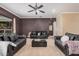 Cozy living room with modern sofas, carpet floor, a ceiling fan, and a large window at 10529 E Posada Ave, Mesa, AZ 85212