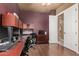 The office features wood floors, a ceiling fan and is decorated with stained wood cabinets and doors at 10529 E Posada Ave, Mesa, AZ 85212