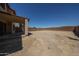 Wide backyard view showing a covered patio and a blank slate of desert landscape for creative possibilities at 12408 W Orange Dr, Litchfield Park, AZ 85340