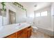 Bathroom with a large mirror, a single sink, and a toilet beside the bath at 12408 W Orange Dr, Litchfield Park, AZ 85340