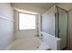 Bright bathroom featuring a soaking tub with large window and a glass-enclosed shower at 12408 W Orange Dr, Litchfield Park, AZ 85340