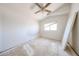 Bedroom with a ceiling fan, window, and neutral-colored walls for relaxation at 12408 W Orange Dr, Litchfield Park, AZ 85340