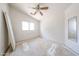 Bedroom with a ceiling fan, a window, and a built-in mirror ready for you to remodel at 12408 W Orange Dr, Litchfield Park, AZ 85340