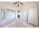 Bedroom with a ceiling fan, an open closet, and a mirror ready to personalize at 12408 W Orange Dr, Litchfield Park, AZ 85340