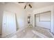Bedroom with a ceiling fan and a view into the upstairs hallway, ready to be refreshed at 12408 W Orange Dr, Litchfield Park, AZ 85340