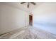 Bedroom with ceiling fan, an open doorway and neutral walls at 12408 W Orange Dr, Litchfield Park, AZ 85340