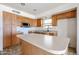 Kitchen with stainless steel appliances, light countertops and wooden cabinets at 12408 W Orange Dr, Litchfield Park, AZ 85340