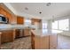 Kitchen with stainless steel appliances, central island, light countertops and wooden cabinets at 12408 W Orange Dr, Litchfield Park, AZ 85340