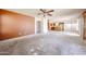 Spacious living room open to the kitchen with tile floors ready for new carpet at 12408 W Orange Dr, Litchfield Park, AZ 85340