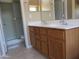 Bathroom with a tile floor, double sinks, and a shower at 12425 W Montebello Ave, Litchfield Park, AZ 85340