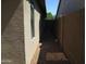 Narrow side yard with low maintenance rock landscaping and a block fence at 12425 W Montebello Ave, Litchfield Park, AZ 85340