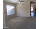 Spacious living room with neutral carpet and natural light streaming in from windows at 12425 W Montebello Ave, Litchfield Park, AZ 85340