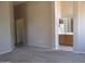 Spacious main bedroom with carpet, bathroom access, and neutral paint tones at 12425 W Montebello Ave, Litchfield Park, AZ 85340