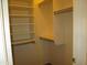 Walk-in closet with open shelving and hanging rods at 12425 W Montebello Ave, Litchfield Park, AZ 85340